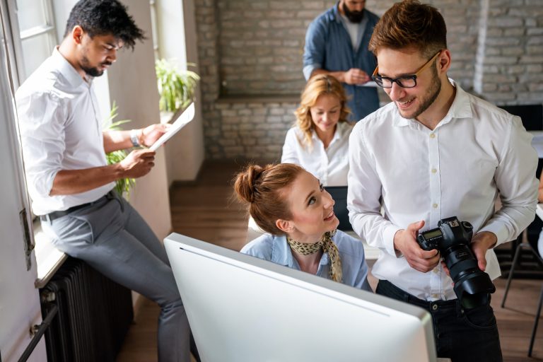 Portrait of creative designer team smiling while working together in the modern office.